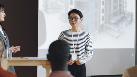 Asian-Female-Speaker-Giving-Presentation-on-Architecture-Conference